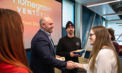 Homegrown Ventures conference with speaker Gus Minor shaking hands with event host Heather Dufour