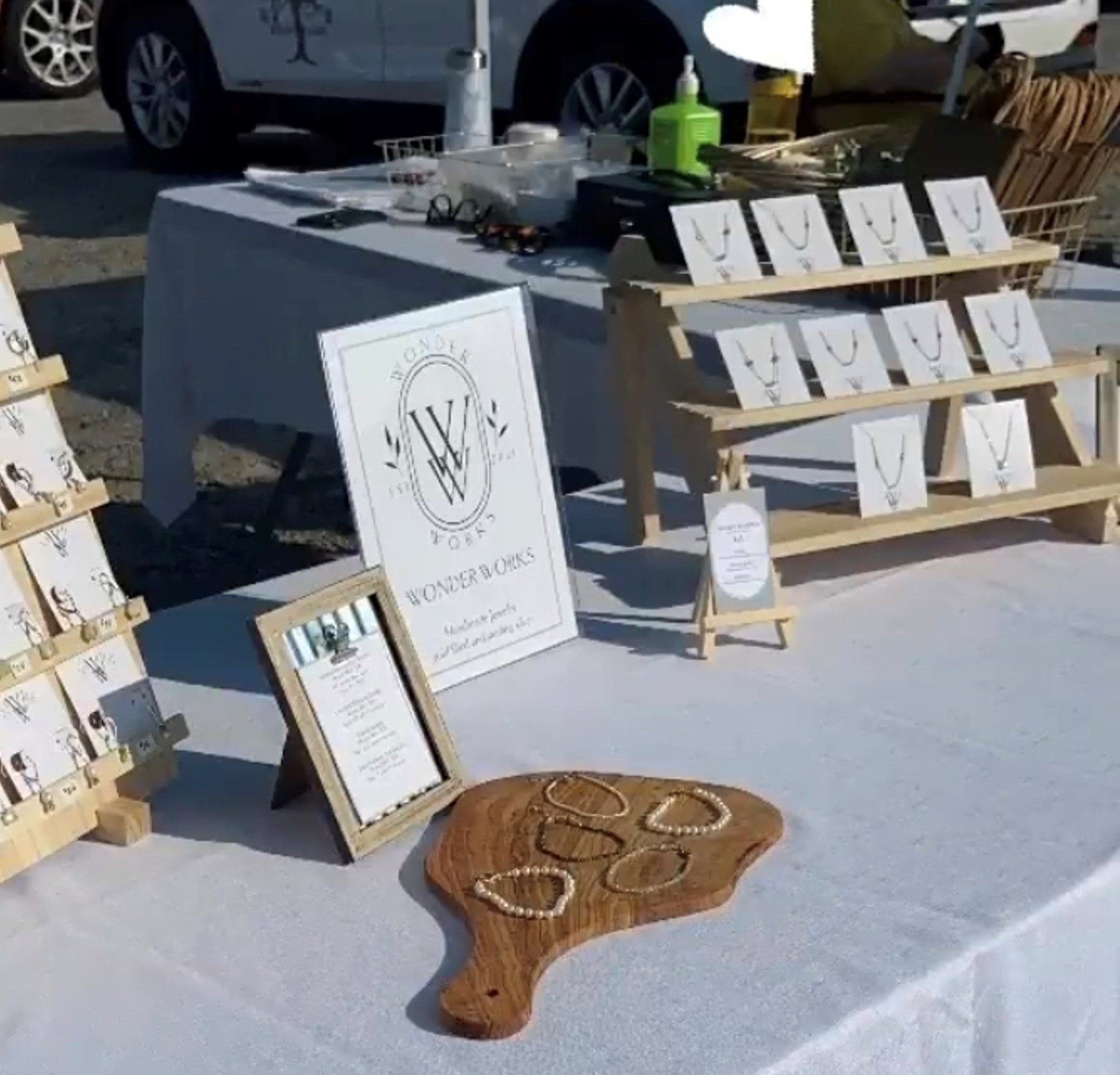 table at a market full of hand made jewelry